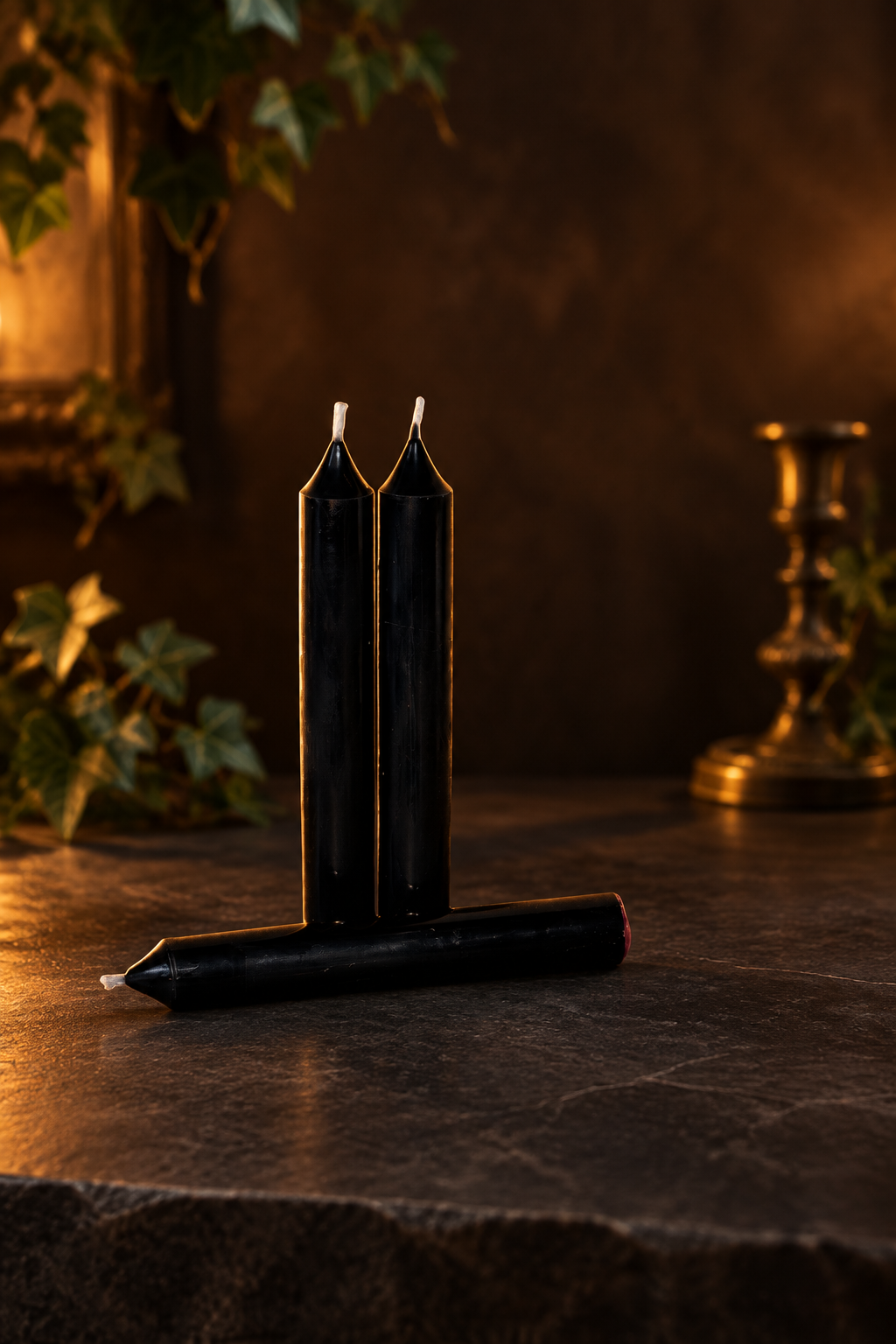Black taper candles in a moody gothic setting